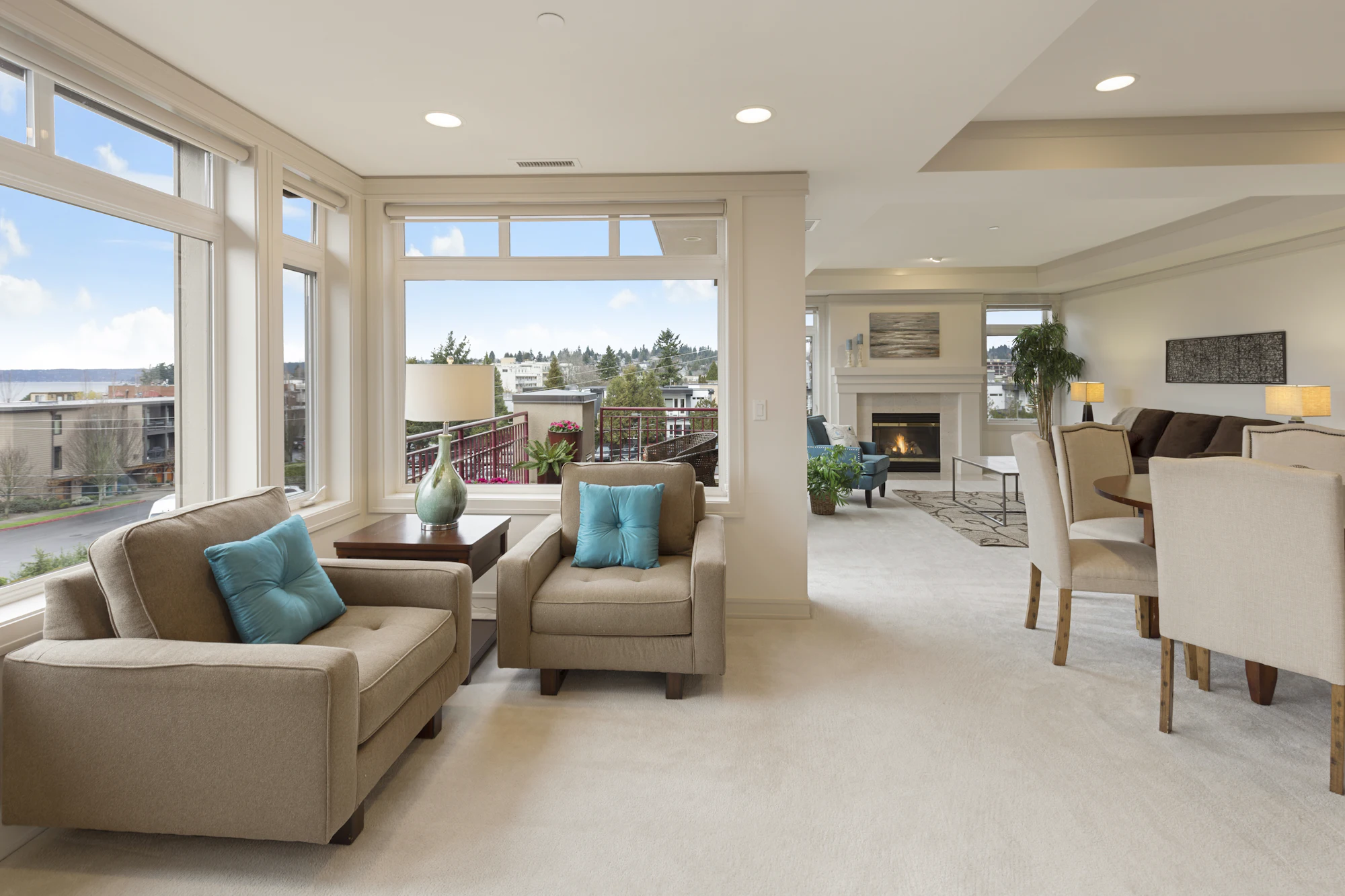 Spacious apartment living room with beige sofas, dining area and panoramic windows